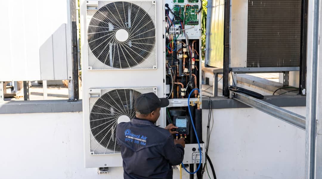 Primal Air technician commissioning a Samsung outdoor unit in Harare